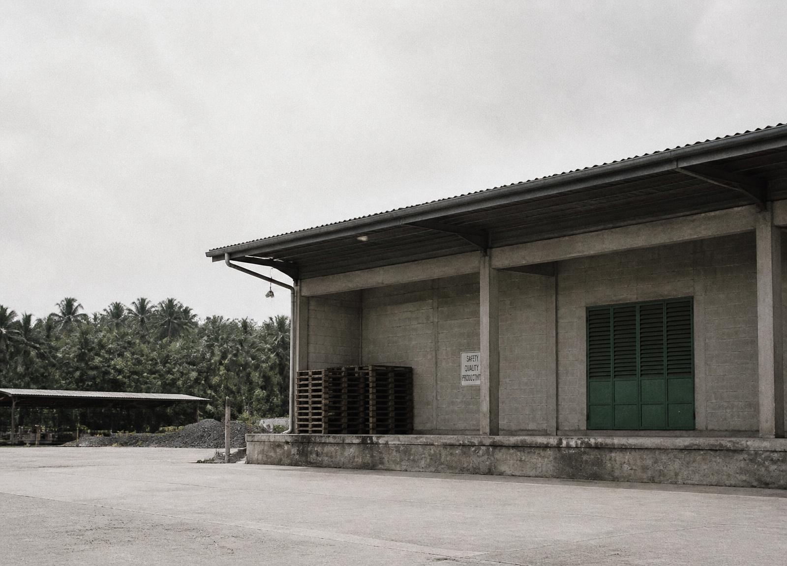 Concrete commodity processing facility under flat tropical light